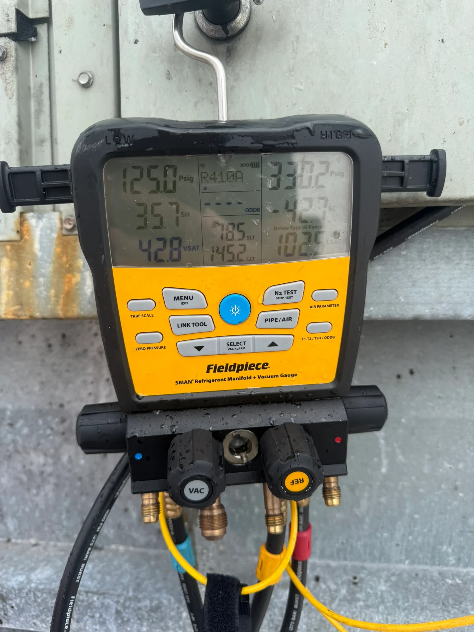 Digital manifold gauges connected during equipment testing