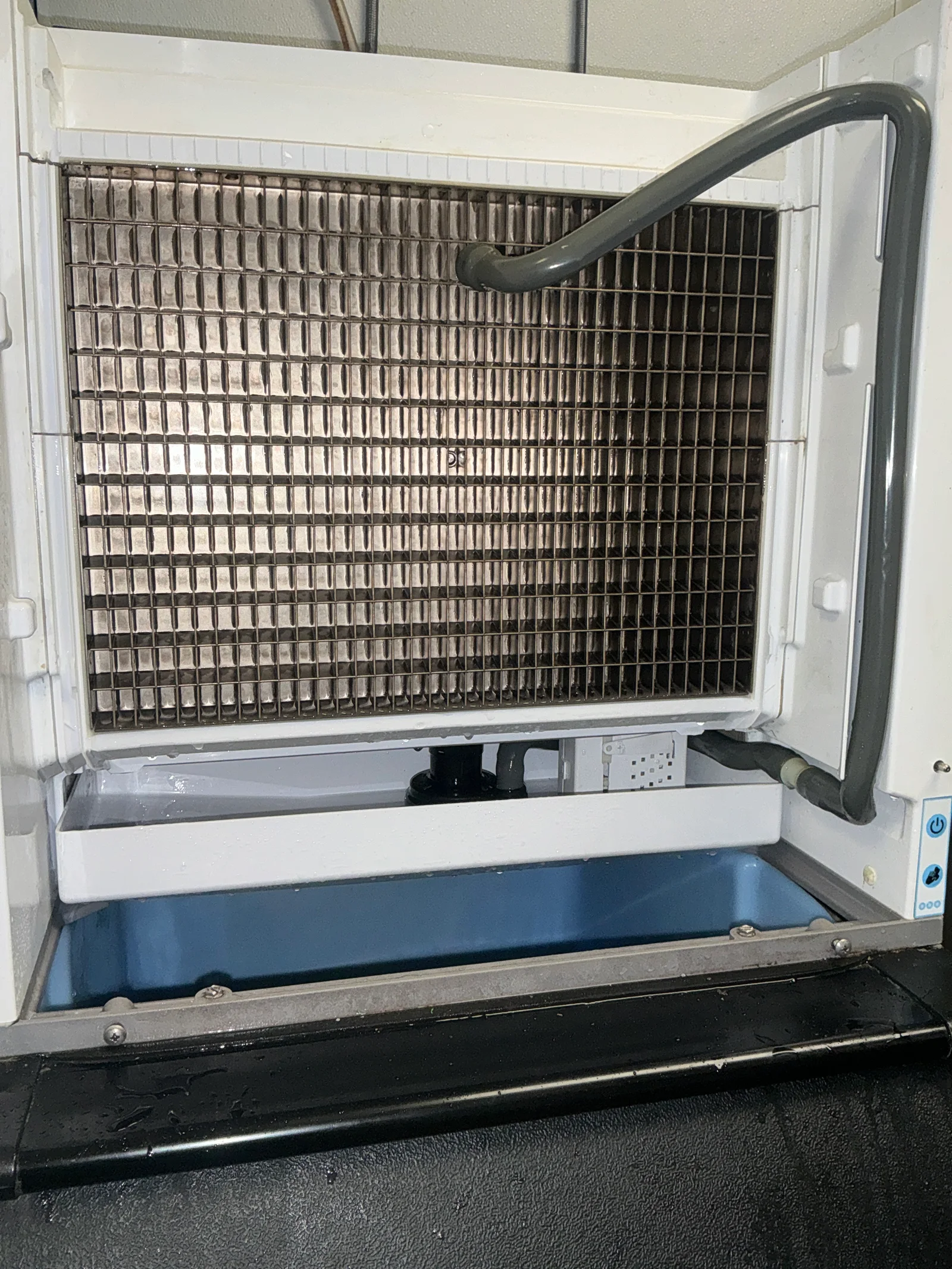 Open ice machine showing the evaporator and ice bin